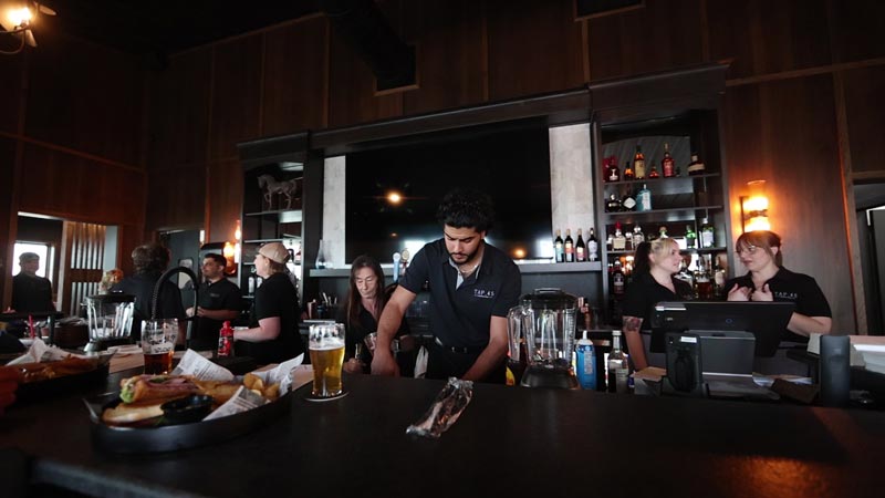 the staff at restaurant tap 45 working at the bar. tap 45 is a tap bar and restaurant that is located inside the defense depot building in mattoon illinois